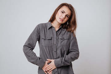 Wall Mural - Sick young woman touching her belly.