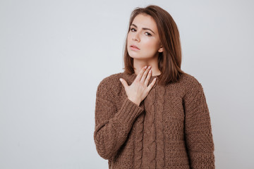 Wall Mural - Sick young woman touching her neck.