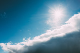 Fototapeta Na sufit - Dramatic Sky, Blue And White Colors. Sun Shine Over Fluffy Cloud