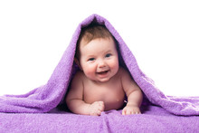 Newborn Baby Lying Down And Smiling In A Purple Towel