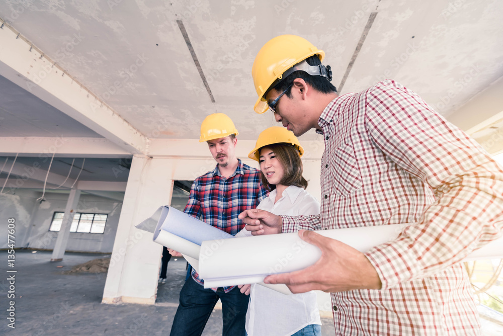 three construction engineers working together in side buiding pl Stock ...