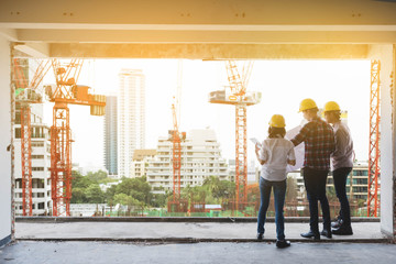 three construction engineers working together in construction si