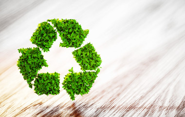 Poster - Fresh green leaf recycle symbol on wooden desk with blurred back