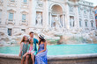 © travnikovstudio - Family near Fontana di Trevi, Rome, Italy. Happy father and kids enjoy italian vacation holiday in Europe.