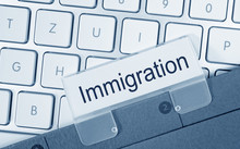 Immigration Folder On Computer Keyboard