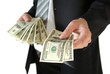 © Oleksandrum - Man in black business suit, holding cash in hands.