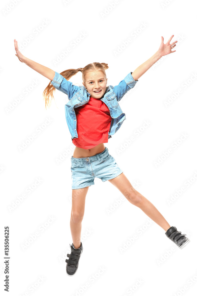 Emotional little girl jumping on white background
