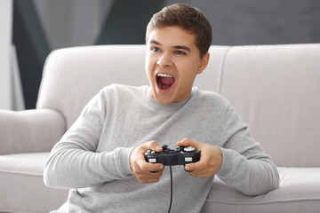 Canvas Print - Teenager playing videogame at home