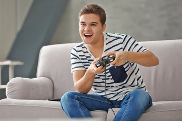 Canvas Print - Teenager playing videogame at home