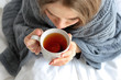 © Africa Studio - Young ill woman with cup of hot tea at home, closeup