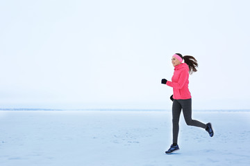 Sticker - Young beautiful woman jogging on winter day