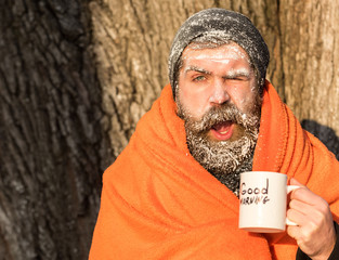 Man in blanket with cup