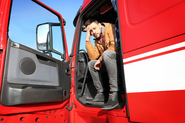 Wall Mural - Driver in cabin of big modern truck