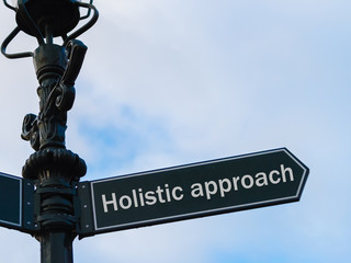 Holistic Approach directional sign on guidepost