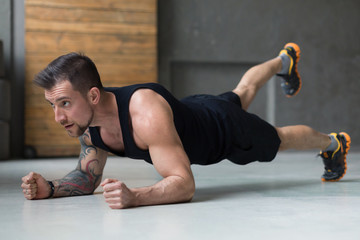 Wall Mural - Young man fitness workout, raised leg plank