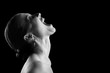 © tugolukof - angry nude girl screaming up on black background