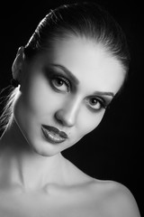 Wall Mural - happy luxury woman model with professional makeup on black background monochrome