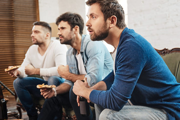 Wall Mural - Serious concentrated men watching a football match