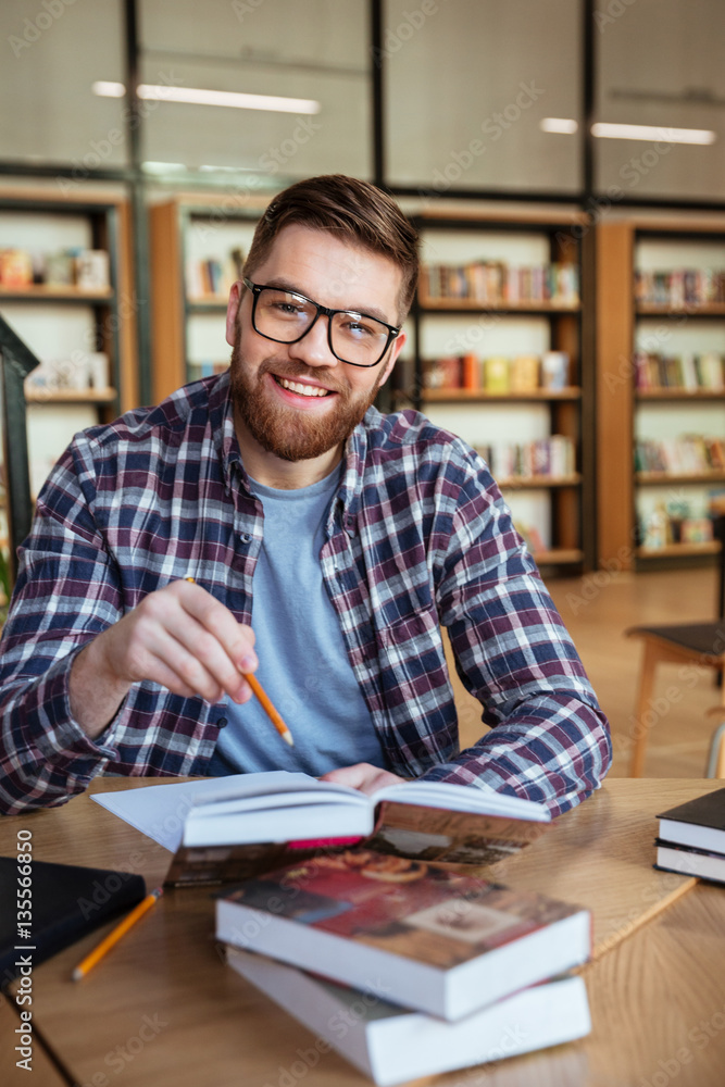 Portrait of a cheerful male student learning at the library Stock Photo ...