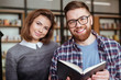 © Drobot Dean - Happy man and woman preparing for exams in library