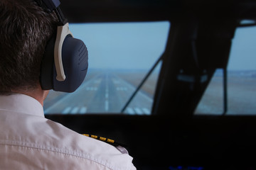 Wall Mural - Pilot in the airlpane cockpit