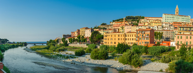 Colorful houses under blue sky in old town of Ventimiglia, Italy.