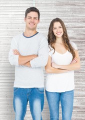 Wall Mural - Smiling couple standing with arms crossed