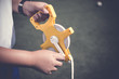 Boy hand holding sport measuring tape or sport equipment tape measure at sport field. Sport equipment measure concept.