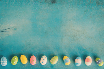 Colorful easter egg on blue pastel color wood background with sp