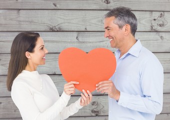 Canvas Print - Romantic couple looking at each other and holding hearts