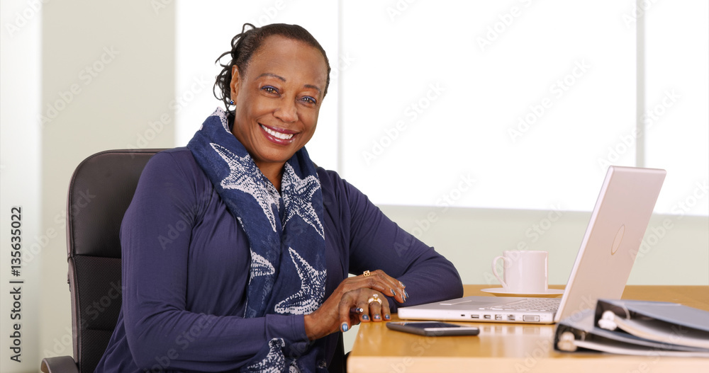 A black businesswoman poses for a portrait at her desk Stock Photo ...