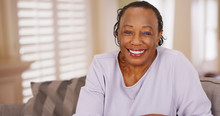 An Older Black Woman Happily Looks At The Camera