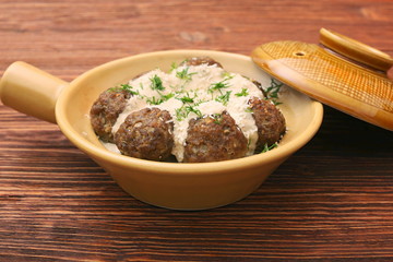 Wall Mural - Meatballs with cream sauce in a ceramic pan