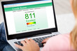 Woman Checking Credit Score Online On Laptop