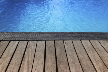 Blue swimming pool summer vacation and wooden deck