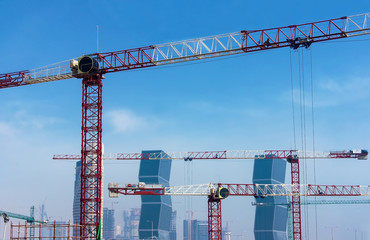 Giant cranes on a background of modern skyscrapers in Doha, Qatar