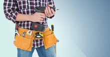Mid Section Of Handy Man With Tool Belt Holding A Drill
