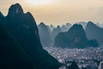 The view at the dawn of the cityscape and karst rock mountains in Yangshuo, Guilin region, Guangxi Province, China.