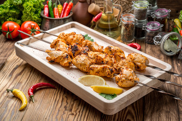 Assorted delicious grilled meat with vegetable on white plate  picnic table for family bbq party