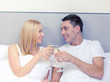 © Syda Productions - smiling couple with champagne glasses in bed