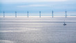 calm surface of Baltic Sea with offshore wind farm