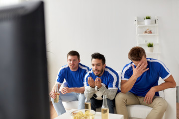 Wall Mural - friends or football fans watching soccer at home