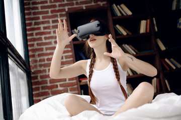 Concept of technology and lifestyle. Woman play the video game with virtual reality device