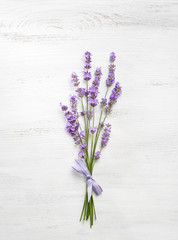 Bundle of lavender on old wooden board painted white.