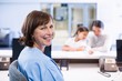 © WavebreakMediaMicro - Portrait of smiling nurse sitting at desk