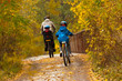 © Iuliia Sokolovska - Family cycling outdoors, golden autumn in park
