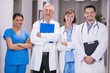 © WavebreakMediaMicro - Portrait of smiling doctors and nurse standing with arms crossed
