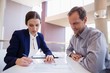 © WavebreakMediaMicro - Business executives discussing over document
