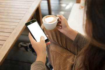 Aufkleber - woman holding phone and coffee in cafe