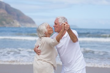 Wall Mural - Senior couple having fun together at beach